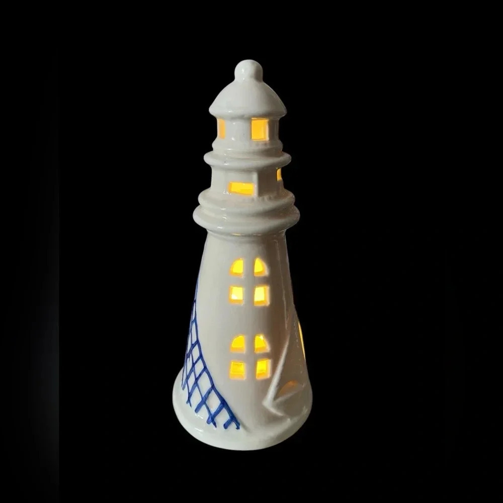 Adorable little ceramic lighthouse in white and blue​